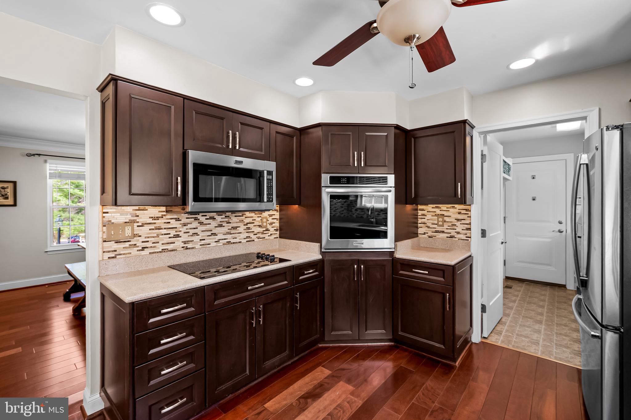 14305 Robcaste Road Phoenix, MD 21131 - Photo 18 of 53 a kitchen with stainless steel appliances granite countertop a stove refrigerator and microwave