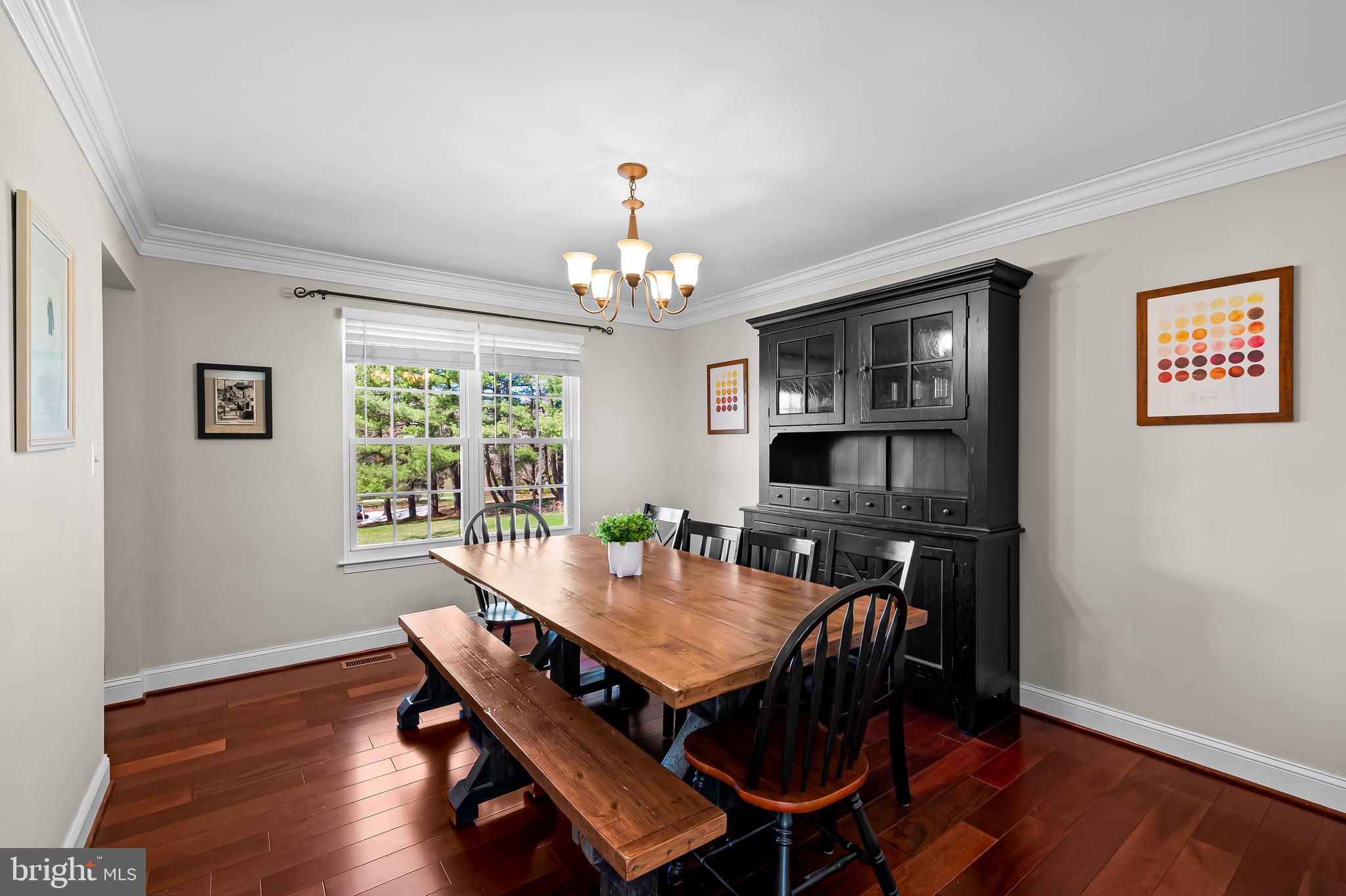 14305 Robcaste Road Phoenix, MD 21131 - Photo 19 of 53 a view of a dining room with furniture window and wooden floor