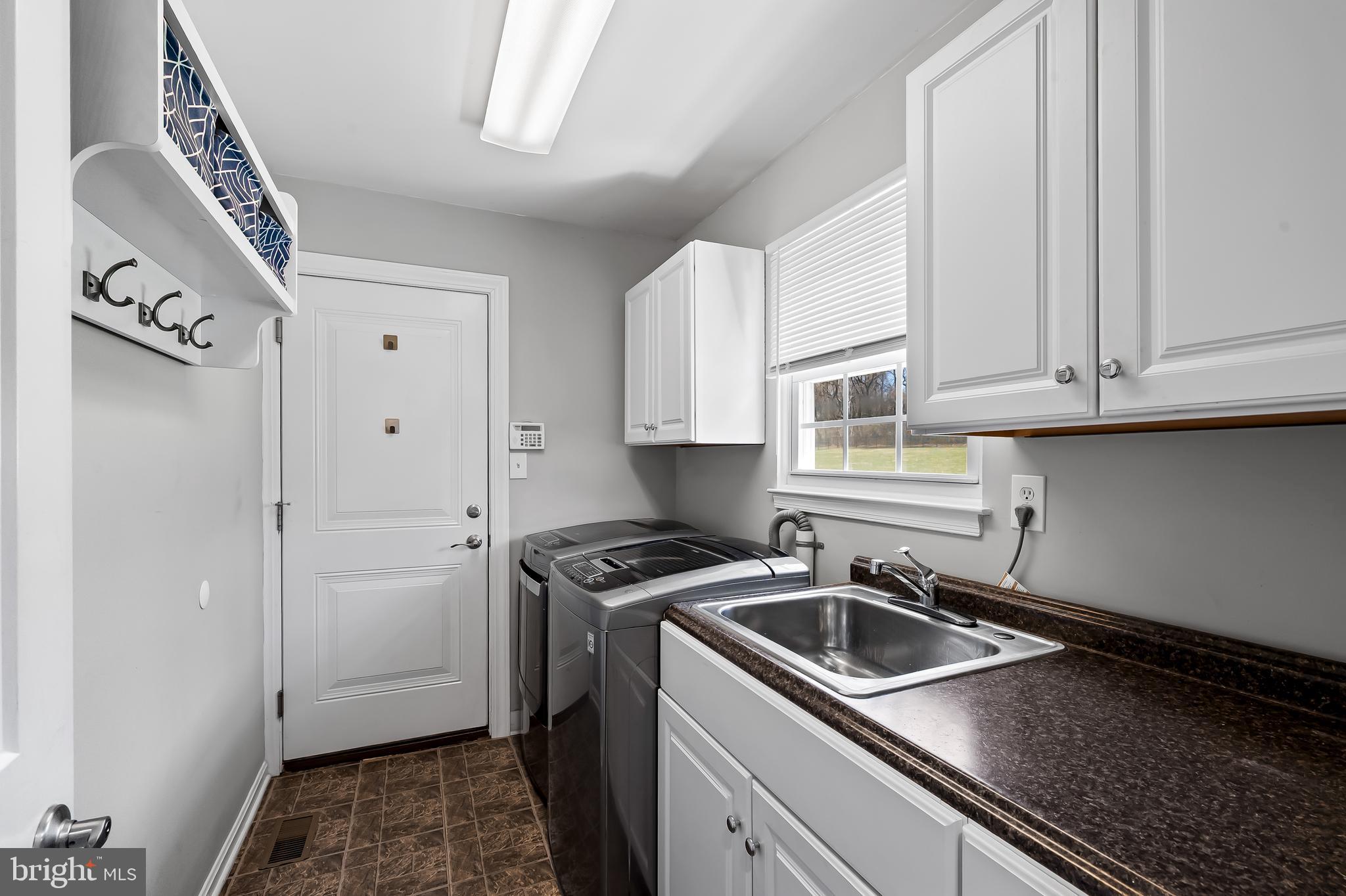 14305 Robcaste Road Phoenix, MD 21131 - Photo 22 of 53 a kitchen with a sink stove and cabinets