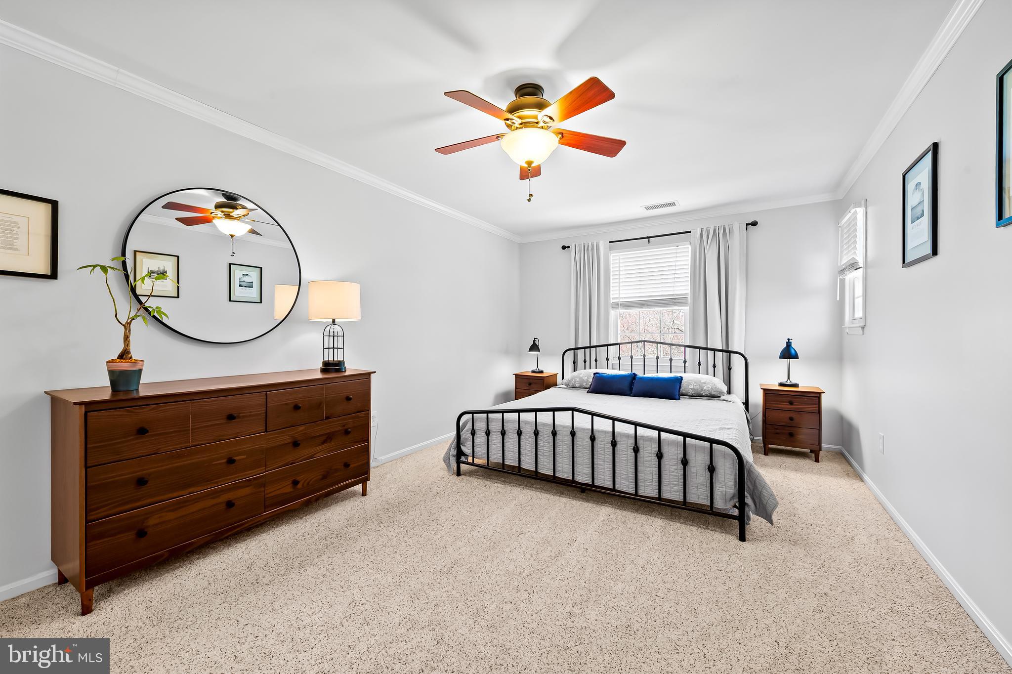 14305 Robcaste Road Phoenix, MD 21131 - Photo 27 of 53 a bedroom with a bed and a chandelier