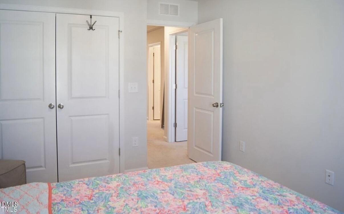 5006 Tura Street Raleigh, NC 27610 - Photo 25 of 32 a bedroom with a bed and a shower