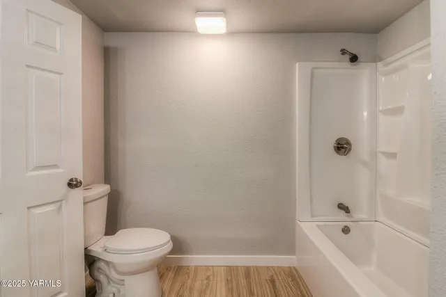 a bathroom with a bathtub and a toilet