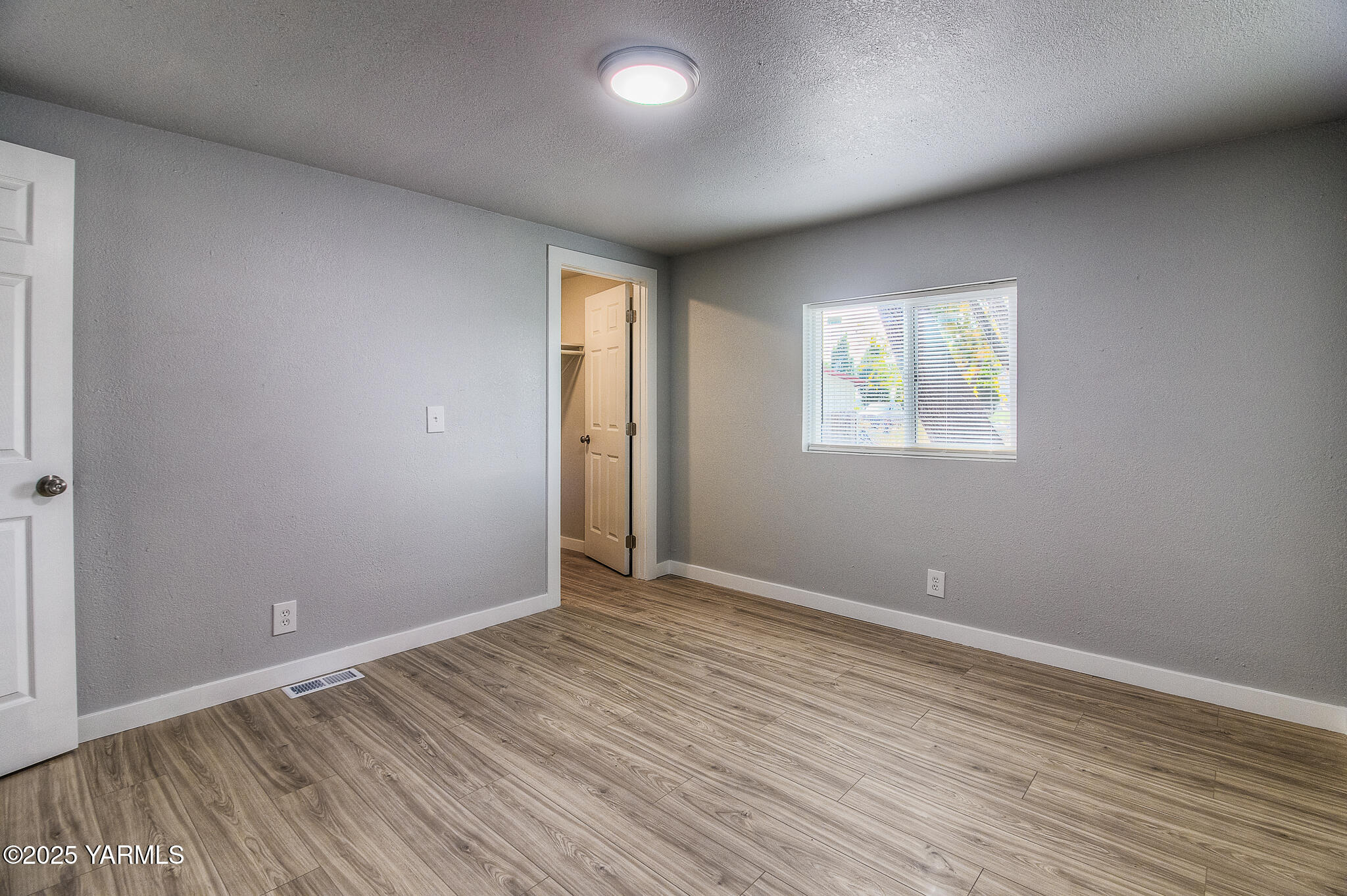 10420 Ahtanum Road Yakima, WA 98903 - Photo 13 of 24 an empty room with wooden floor and windows