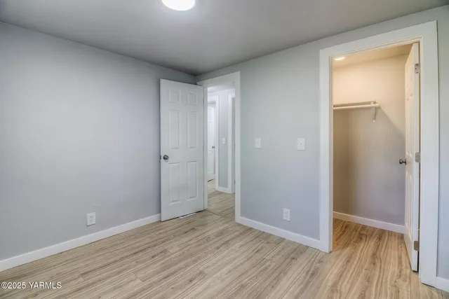 a view of an empty room and wooden floor