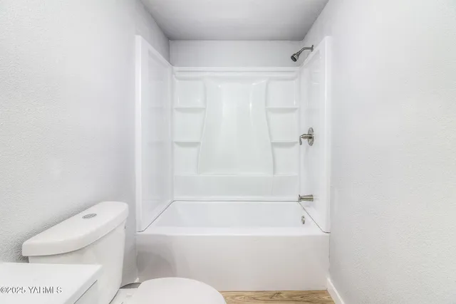 a bathroom with a toilet and a bathtub