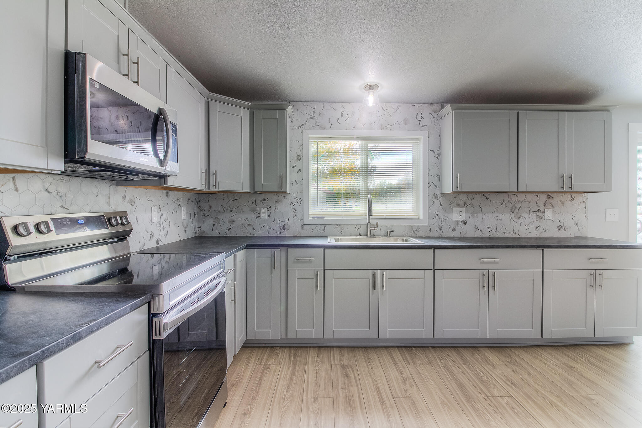 10420 Ahtanum Road Yakima, WA 98903 - Photo 6 of 24 a kitchen with stainless steel appliances granite countertop a stove a sink and a microwave