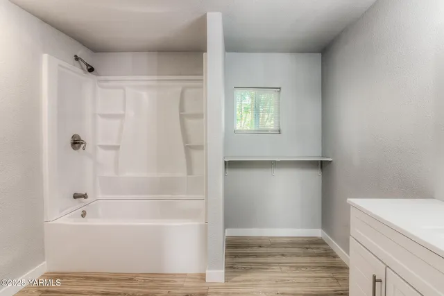 a bathroom with a bathtub and a shower