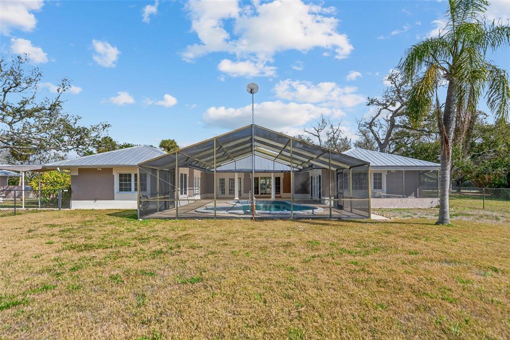 7108 Midnight Pass Road Sarasota, FL 34242 - Photo 54 of 83 a front view of a house with a yard