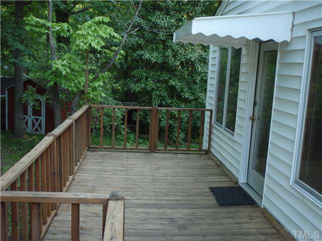 2921 Barmettler Street Raleigh, NC 27607 - Photo 3 of 12 a view of balcony with wooden floor and fence