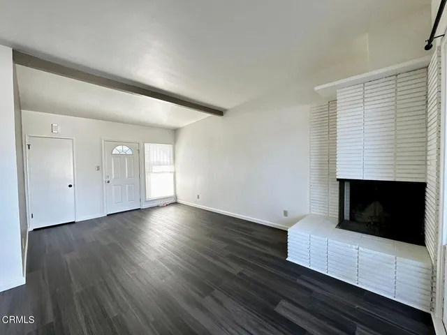 a living room with hard wood floors and a window