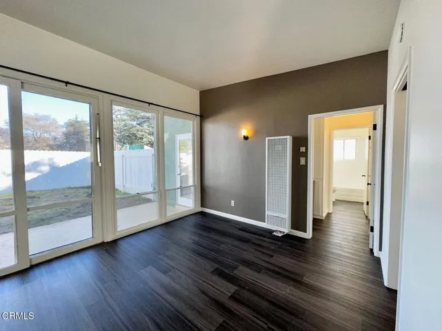 a view of a room with wooden floor