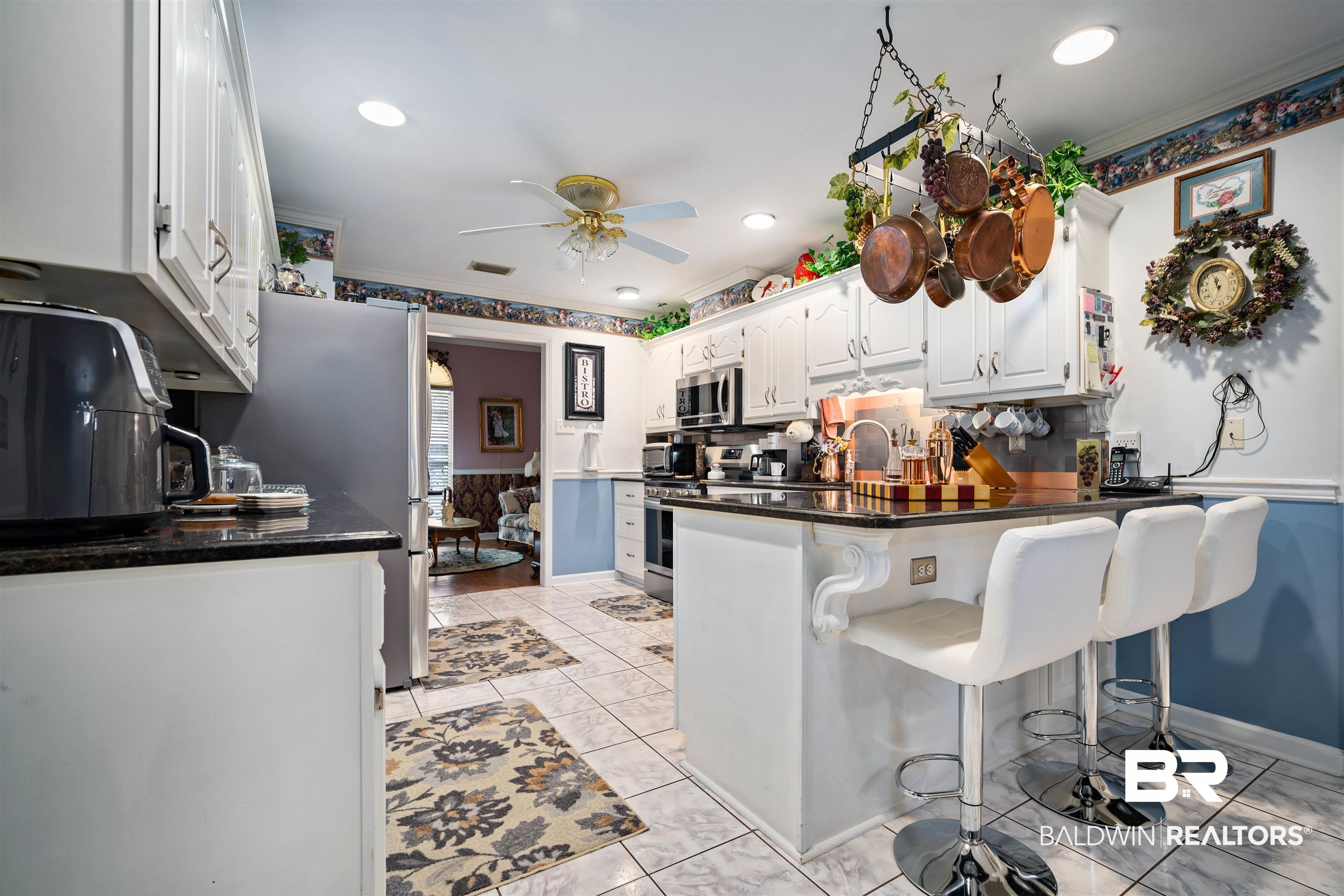 1744 Aden Road Mobile, AL 36695 - Photo 9 of 35 Kitchen featuring white cabinets, ceiling fan, tasteful backsplash, kitchen peninsula, and appliances with stainless steel finishes