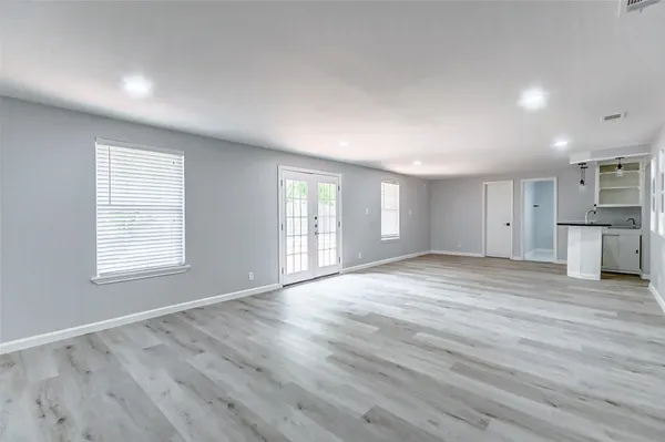 a view of an empty room with wooden floor