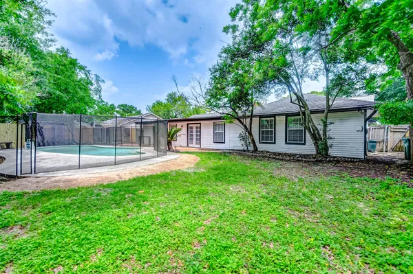 a view of a backyard with a tub and trees