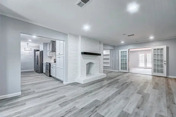 a view of a kitchen with a stove cabinets and wooden floor