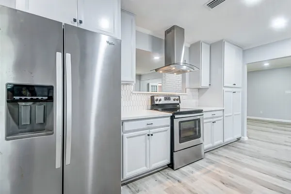 a kitchen with stainless steel appliances a refrigerator stove and sink