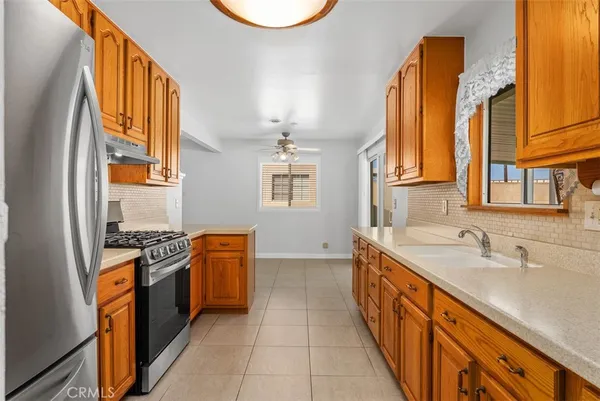 a stove top oven sitting inside of a kitchen