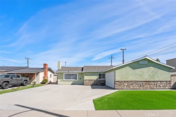 a view of a house with a yard and garage