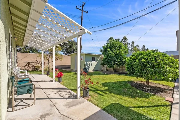 a view of a house with backyard porch and sitting area