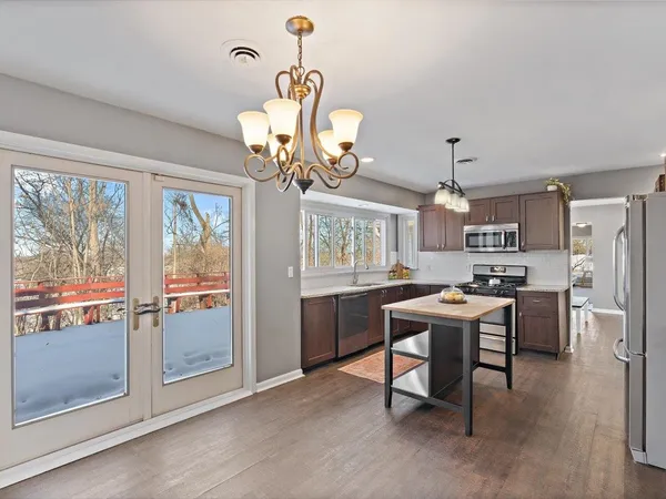 a kitchen with a stove a sink and a refrigerator
