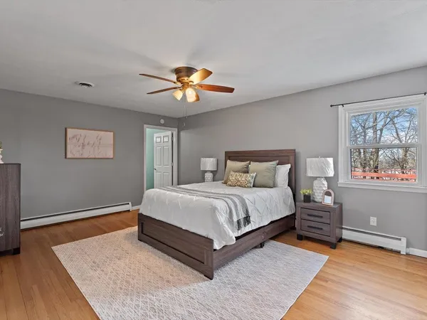 a bedroom with a bed and a ceiling fan