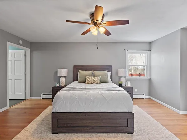 a bedroom with a bed and a chandelier