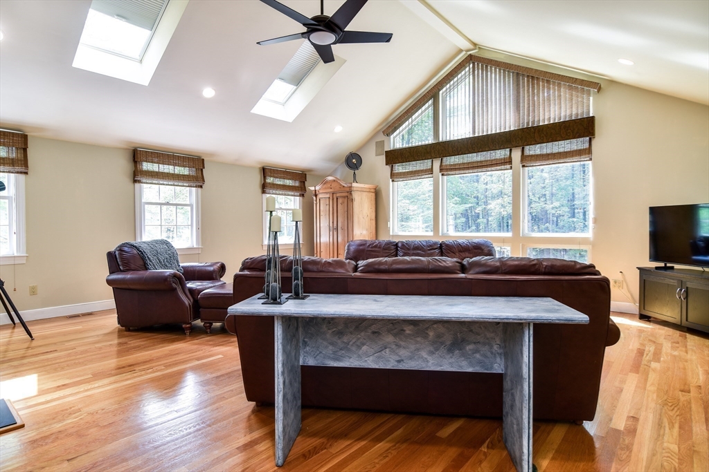 114 Hunters Ridge Road Concord, MA 01742 - Photo 17 of 38 a living room with a couch a flat screen tv and windows