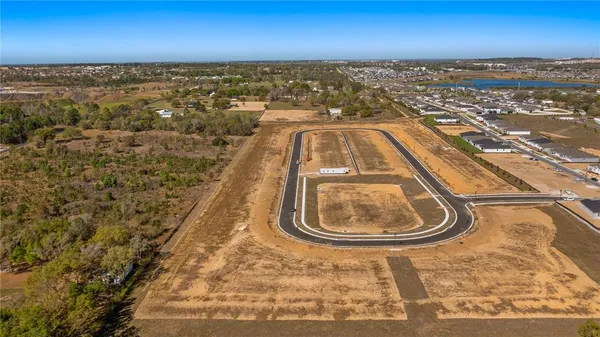 a view of open field with trees in background
