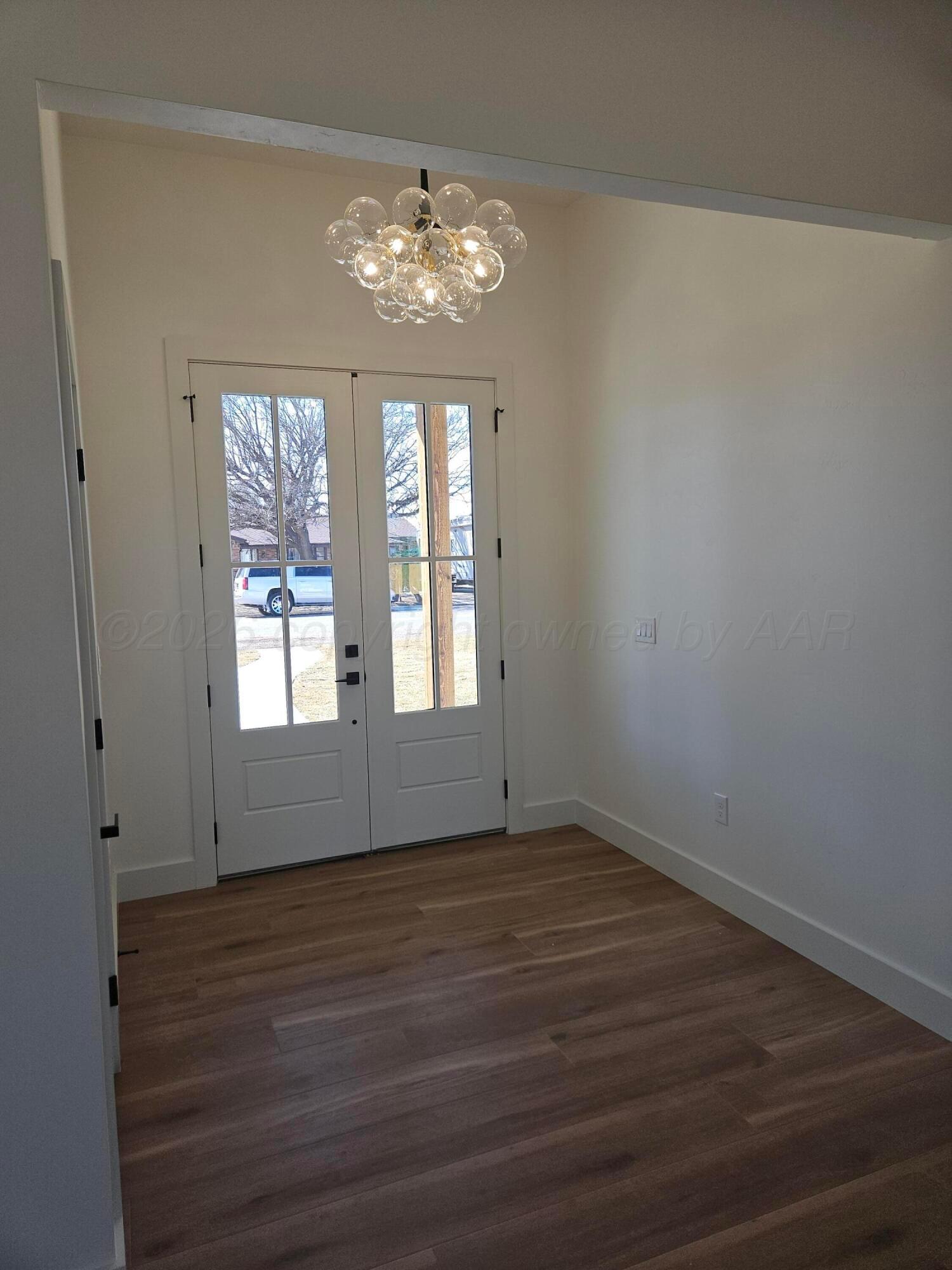 1010 Oak Avenue Panhandle, TX 79068 - Photo 12 of 44 a view of an empty room with wooden floor and a window