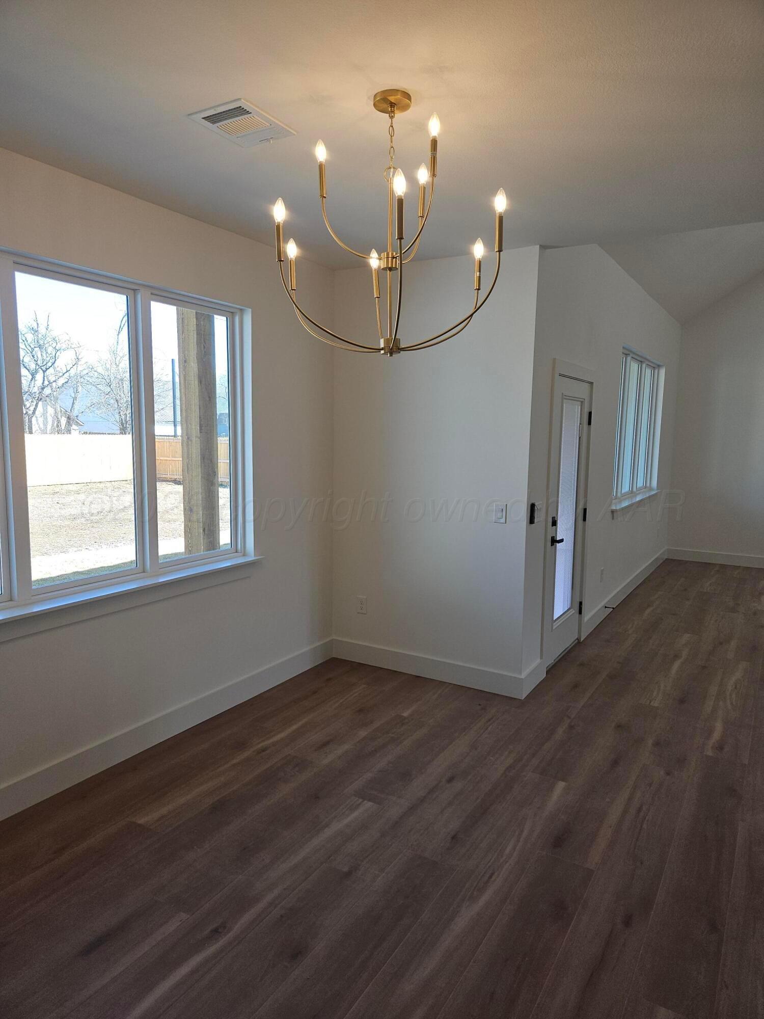 1010 Oak Avenue Panhandle, TX 79068 - Photo 14 of 44 wooden floor in an empty room with a window