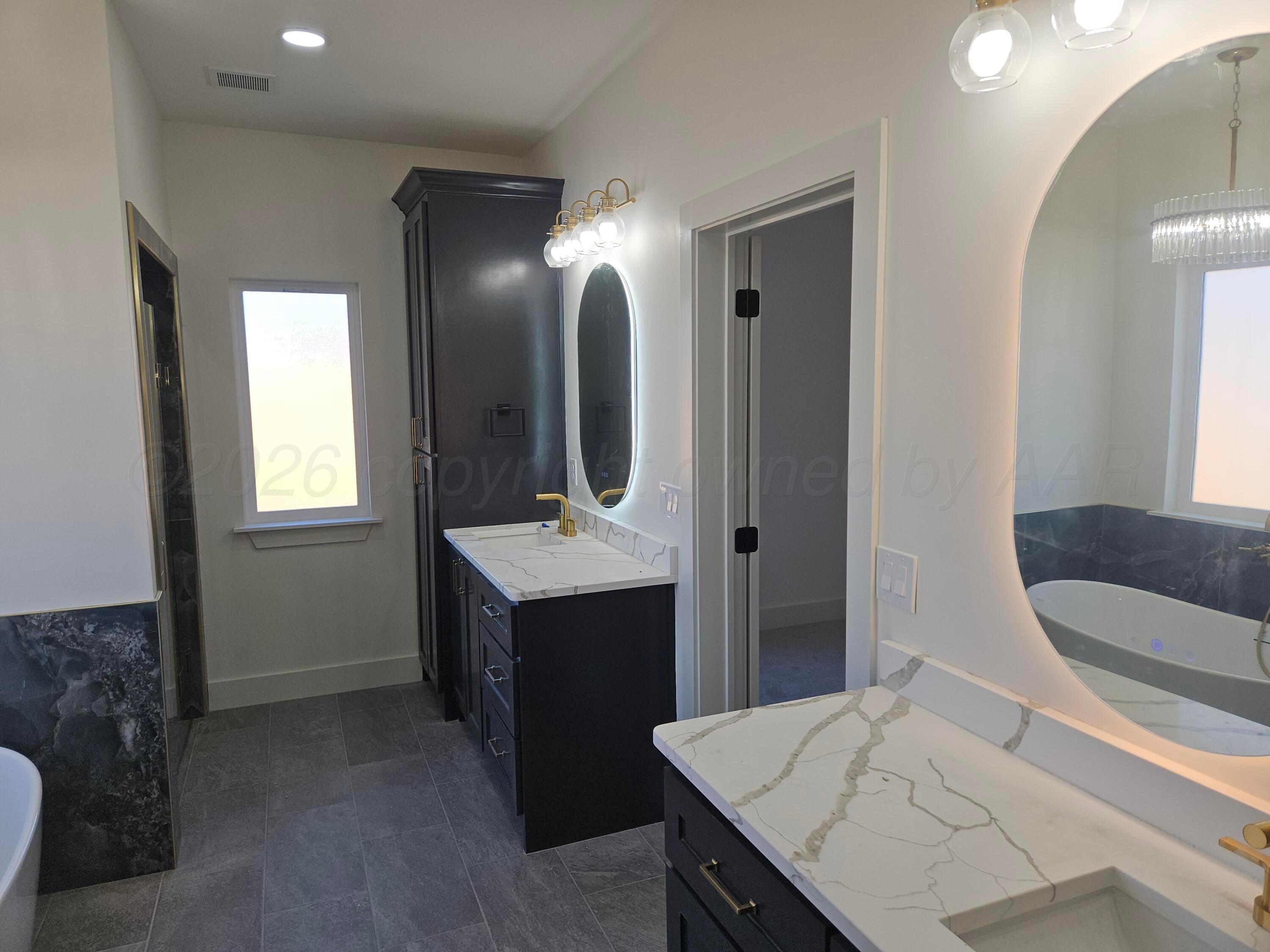 1010 Oak Avenue Panhandle, TX 79068 - Photo 25 of 44 a bathroom with a sink and a mirror