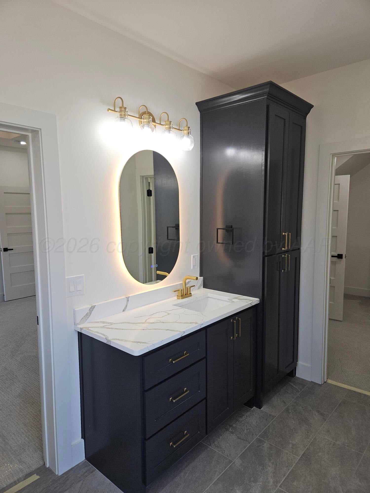 1010 Oak Avenue Panhandle, TX 79068 - Photo 27 of 44 a bathroom with a granite countertop sink and a mirror