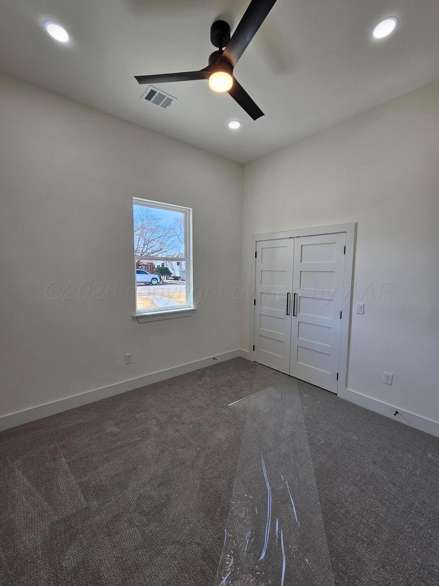 1010 Oak Avenue Panhandle, TX 79068 - Photo 35 of 44 en empty room with ceiling fan and window