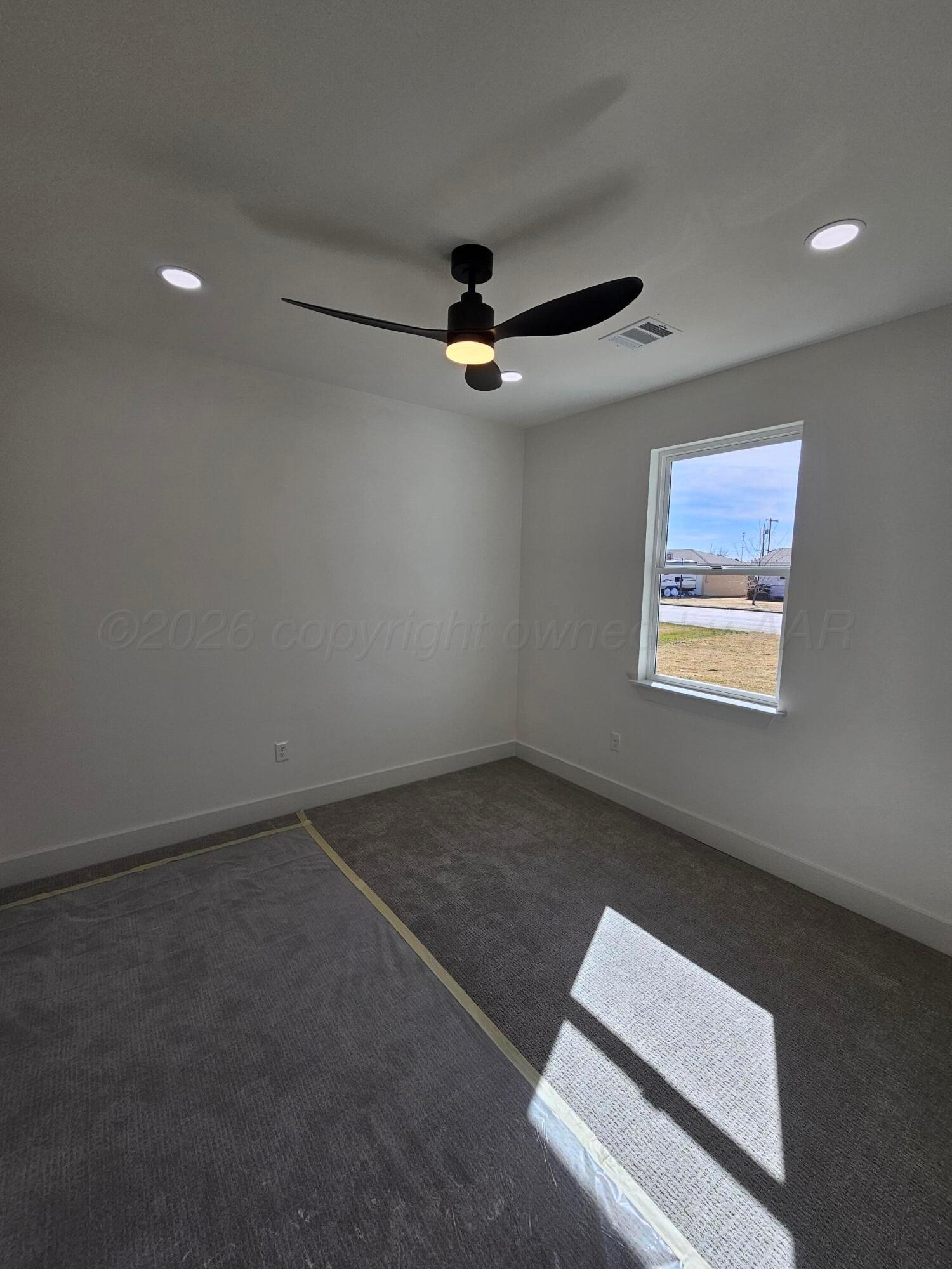1010 Oak Avenue Panhandle, TX 79068 - Photo 36 of 44 an empty room with a ceiling fan and window