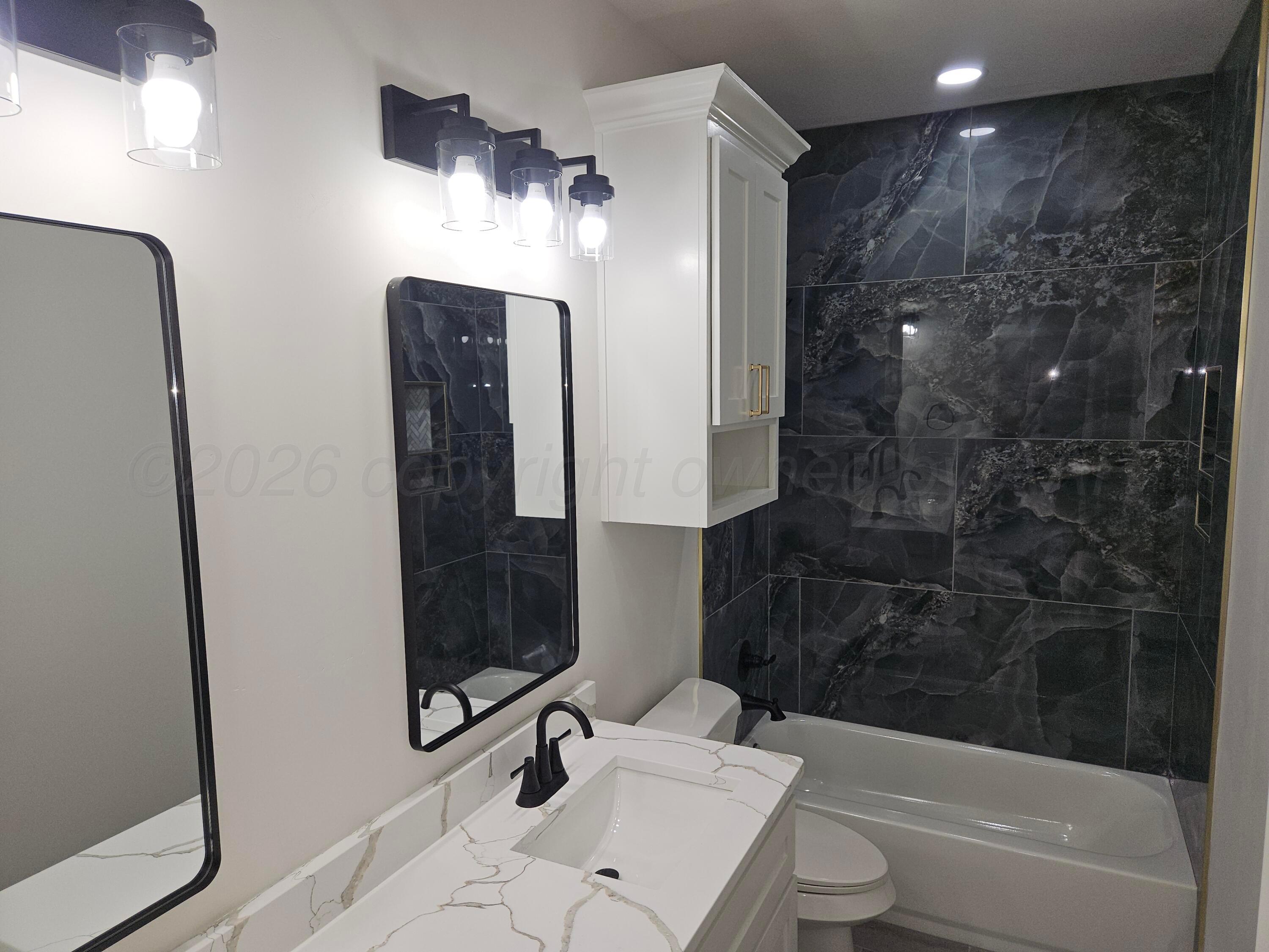 1010 Oak Avenue Panhandle, TX 79068 - Photo 38 of 44 a bathroom with a sink a toilet and shower