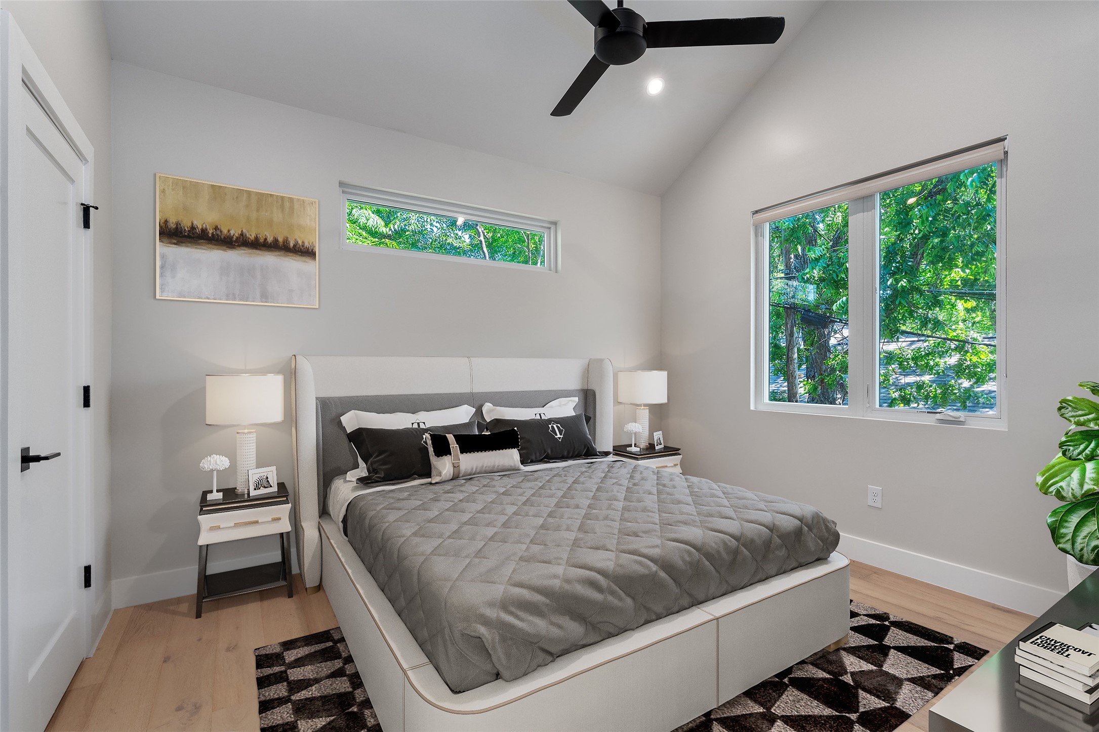 5200 Grover Avenue Austin, TX 78756 - Photo 15 of 32 Virtually Staged. Primary Bedroom, bright and airy. Vaulted ceilings enhance this space, featuring large windows, clerestory windows, and light wood-finish flooring