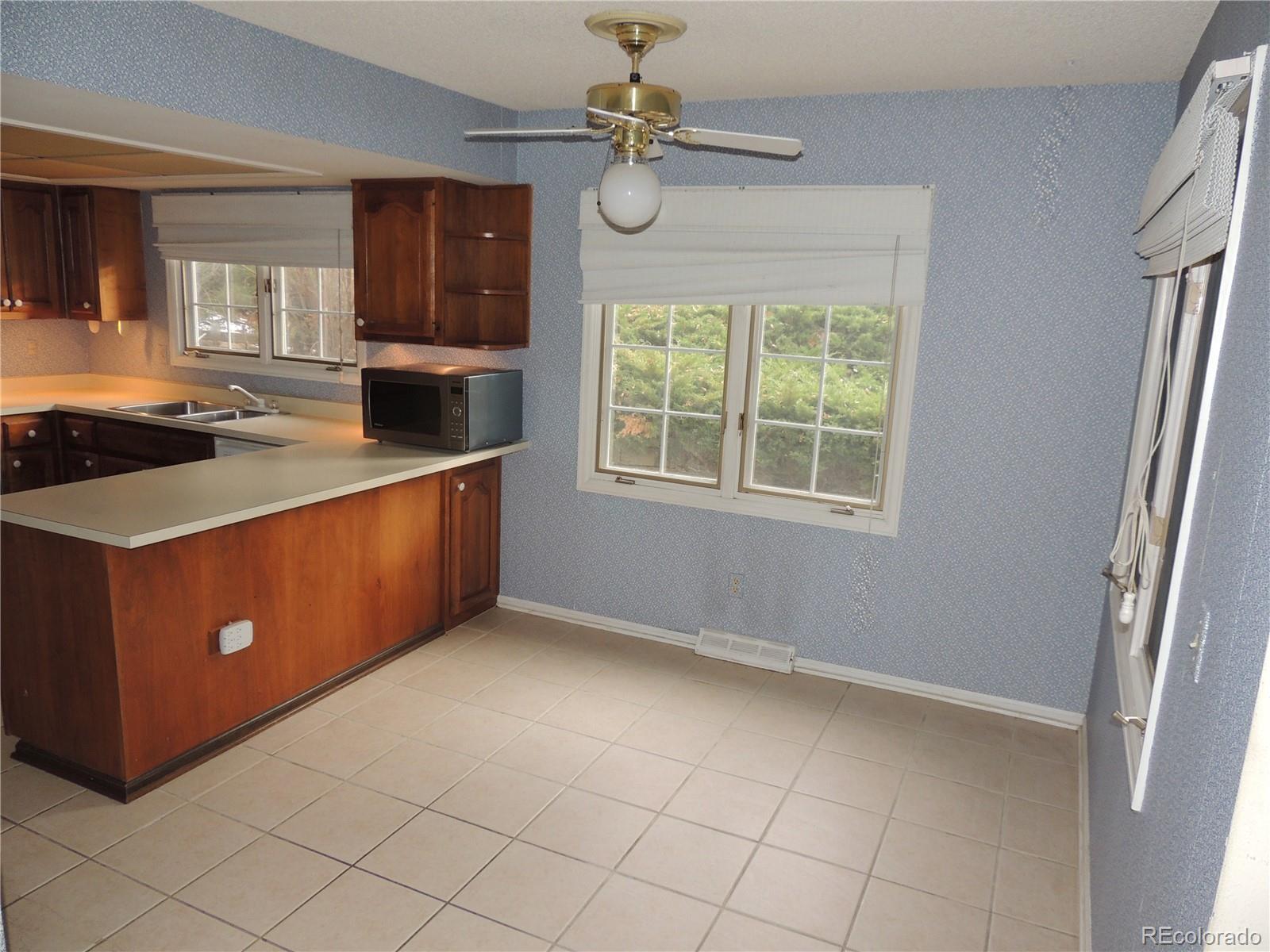 4530 South Verbena Street, Unit 322 Denver, CO 80237 - Photo 13 of 27 a kitchen with stainless steel appliances granite countertop a stove a sink and a refrigerator