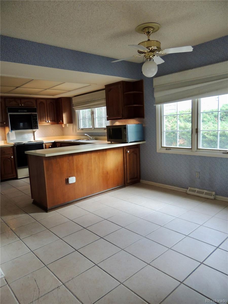4530 South Verbena Street, Unit 322 Denver, CO 80237 - Photo 14 of 27 a view of kitchen with granite countertop cabinets and window
