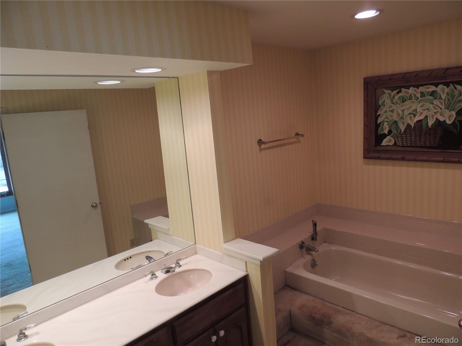 4530 South Verbena Street, Unit 322 Denver, CO 80237 - Photo 19 of 27 a bathroom with a tub sink and mirror