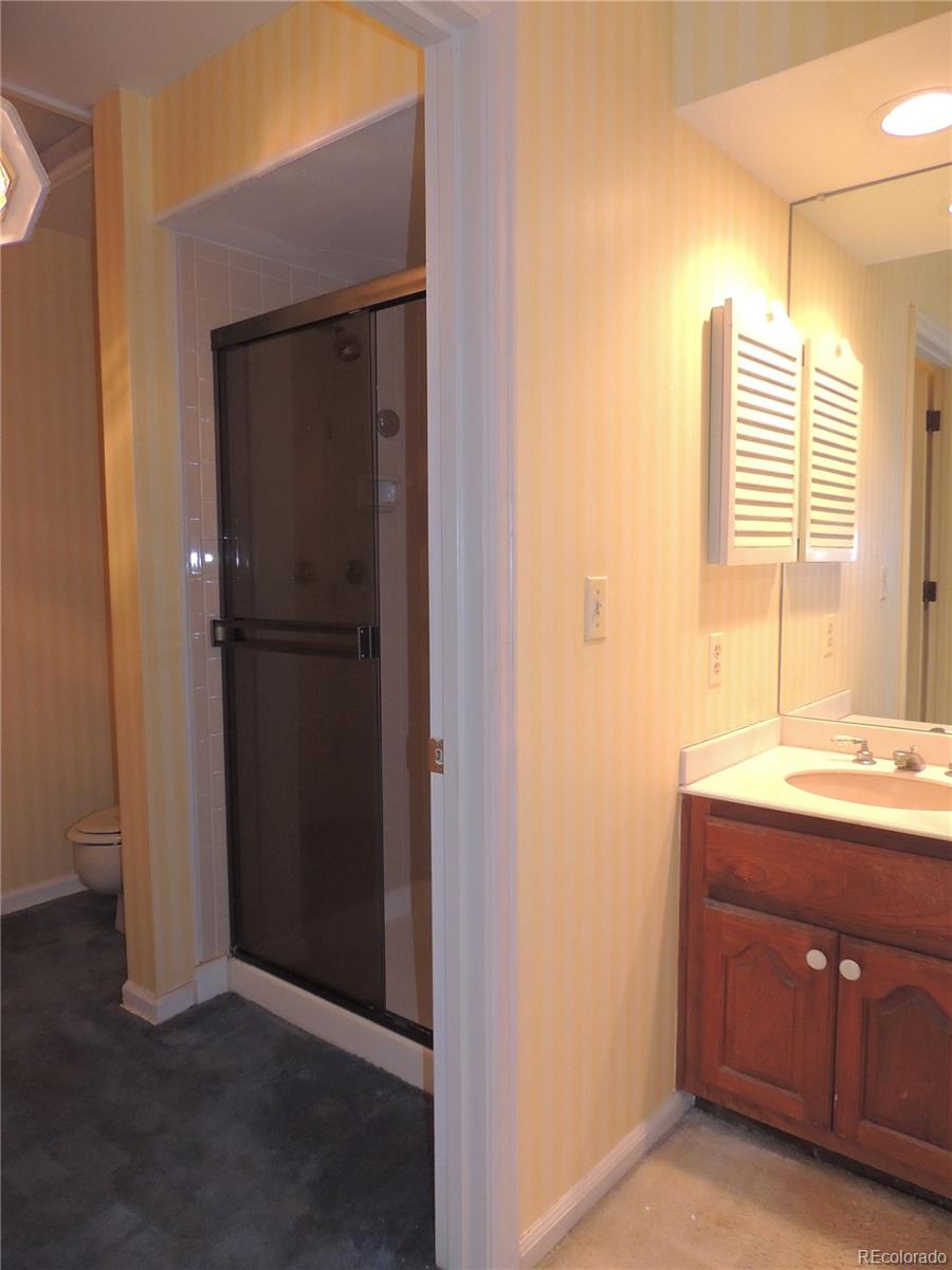 4530 South Verbena Street, Unit 322 Denver, CO 80237 - Photo 20 of 27 a room with a sink and a mirror
