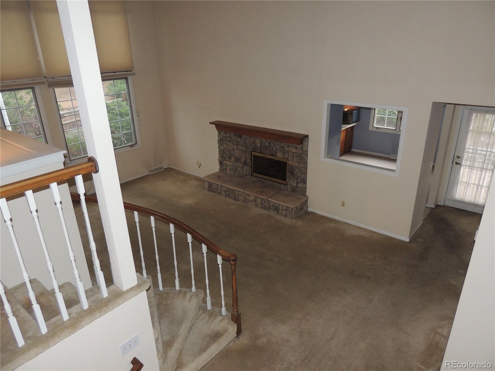 4530 South Verbena Street, Unit 322 Denver, CO 80237 - Photo 23 of 27 a view of a livingroom with wooden floor and stairs