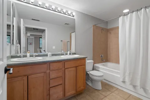 a bathroom with a toilet a sink and a large mirror