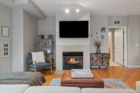 a living room with furniture fireplace and flat screen tv