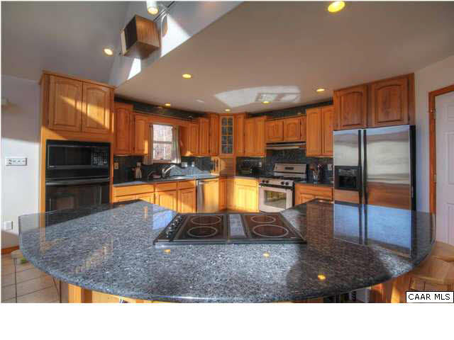27 Tanglewood Road Palmyra, VA 22963 - Photo 6 of 23 A Chef's Delight - a seated conversation/tasting bar right in front of the range - perfect for those who like to visit while they prepare meals.