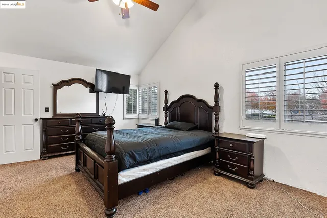 a bedroom with a bed and dresser with mirror
