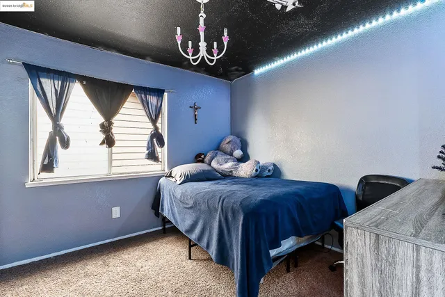 a bedroom with a bed and window