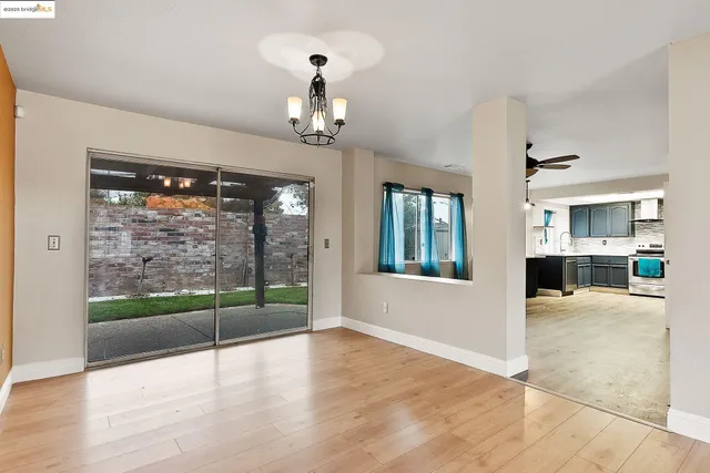 a view of a livingroom with furniture wooden floor and windows