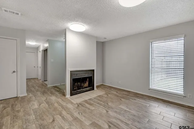 a view of empty room with a fireplace