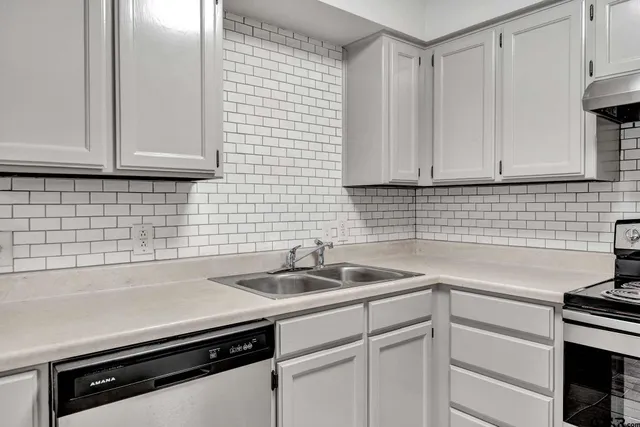 a kitchen with a sink and cabinets