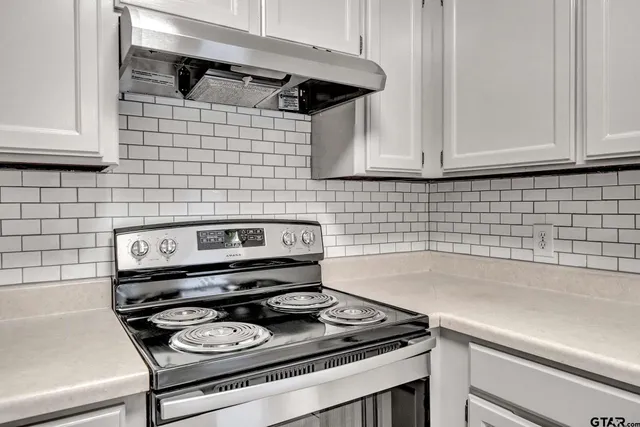 a stove top oven sitting inside of a kitchen